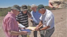 Scouting for uranium at Blue Sky Uranium's Santa Barbara project in Argentina. From left to right: David Terry, Ron McMillan, Clifton Farrell and Jorge Berrizzo. Inset: A piece of petrified wood found at Santa Barbara.