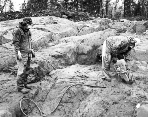 Houston Lake Mining technicians Curtis Mandamin (left) and John Robinson channel sample the No. 2 Vein at the Dogpaw Lake gold property, in Ontario.