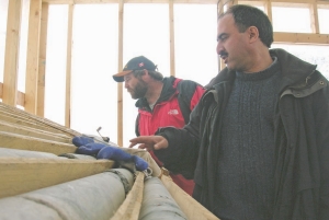 Michael Burke, head of mineral services for the Yukon government (on the left) and Farshid Ghazanfari, a geological technical co-ordinator and consultant with Largo Resources, inspect core at the company's Northern Dancer tungsten-moly project, in the Yukon.