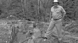 Dean Cutting, project manager for Houston Lake Mining's Dogpaw Lake gold property, poses on a gold mineralized outcrop. The property, which is near Kenora, Ont., is littered with small pods of near-surface mineralization.