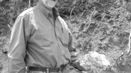 Warren Thompson, Fronteer Development Group's senior exploration geologist, points to a showing of mineralization at the company's 51%-owned Long Canyon gold project in Elko Cty., Nev.