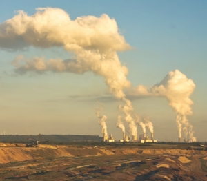 Open-pit mining for lignite in Germany, while power stations burn brown coal in the horizon. Despite fierce debate in the mining industry about global warming, some companies are bracing themselves for the inevitable regulation of carbon emissions.