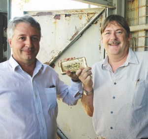 Brent Butler, ATW Gold president and CEO (left), and David Stone, chief operating officer, pose with the company's first gold dor bar from the new Burnakura underground gold mine in Western Australia.