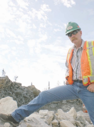 Bruce Parker, corporate manager of mine operations for Apollo Gold, strikes a pose as the company's Black Fox gold project, in the Timmins mining district of Ontario.