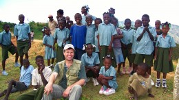 Eurasian president and CEO David Cole, surrounded by children at the Treuil camp in northwestern Haiti.