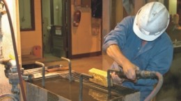 A worker processes a gold dor bar at Yukon-Nevada Gold's Jerritt Canyon project site in Nevada.