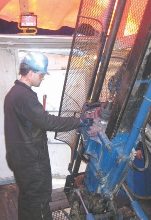 A worker operates a drill at Alto Ventures' Coldstream gold project in Ontario.