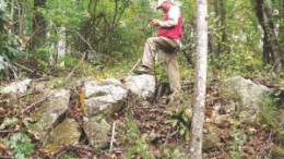 Consultant Lamont Leatherman notes a spodumene pegmatite outcrop at North Arrow Minerals' Beaverdam project.