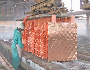 A worker inspects copper sheets at Katanga Mining's Luilu metallurgical plant in the Democratic Republic of the Congo.