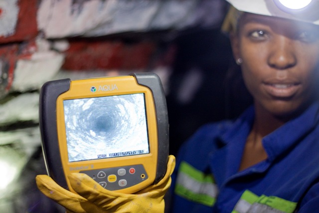 A worker displays a drill-hole-camera image at Great Basin Gold's new Burnstone gold mine in South Africa. Photo by Ian Bickis.