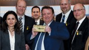 Osisko Mining president CEO Sean Roosen (centre) hoists the company's first gold bar, with members of the executive team at the company's general meeting in May. Photo by Osisko Mining