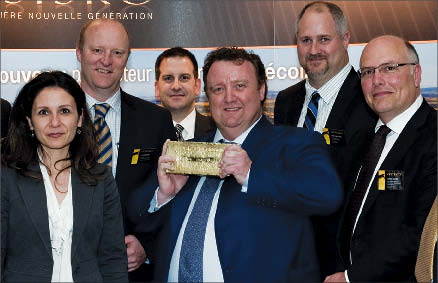 Osisko Mining president CEO Sean Roosen (centre) hoists the company's first gold bar, with members of the executive team at the company's general meeting in May. Photo by Osisko Mining