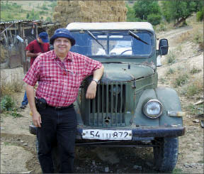 Geologist Ricardo Valls leans on a Soviet-era vehicle at Caldera Resources' Marjan gold-silver project in southern Armenia. Photo by Caldera Resources