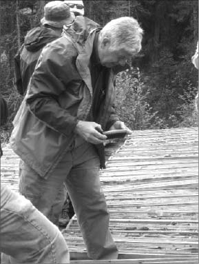 First Point Minerals president and CEO Peter Bradshaw examines awaruite core at the Decar nickel-iron ore project in central British Columbia. Photo by Matthew Allan