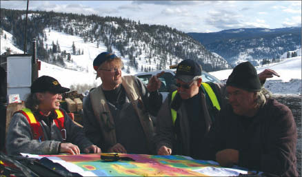 Studying a map at Sego Resources' Miner Mountain project in Princeton, British Columbia, from left: CEO J. Paul Stevenson, project manager Curt Kauss, director Al Hilton and reclamation and site preparation manager Bob Dennis. Photo by Ian Bickis