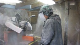 A worker splits core at Avanti Mining's Kitsault molybdenum project in northern British Columbia. Photo by Avanti Mining