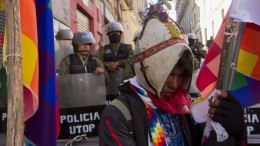 A protester opposed to South American Silver's Malku Khota silver project stands in front of a barrier blocking access to the Bolivian presidential palace in the capital La Paz. Photo by Alexis Aubin. al.aphoto@hotmail.com. alexisaubin.blog.com