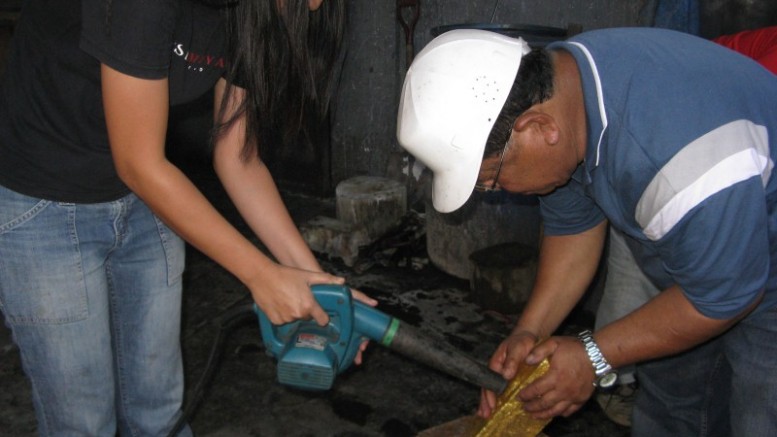 Tidying up after a gold pour at Medusa Mining's Co-O gold mine in Mindanao, Philippines. Photo by Trish Saywell