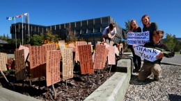 Members of the Peel Youth Alliance "stake the ground" outside the Yukon legislature with the names of Yukoners who support PYA's campaign to extend the staking ban on the Peel watershed. From left: Malkolm Boothroyd, Cassy Andrew, Amber Lammers and Graeme Poile. Photo by Peel Youth Alliance