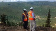 Victoria Gold VP of exploration Rich Eliason (right) and a colleague look over Haggart Creek and the exploration camp at the Dublin Gulch gold project in the Yukon. Photo by Matthew Keevil