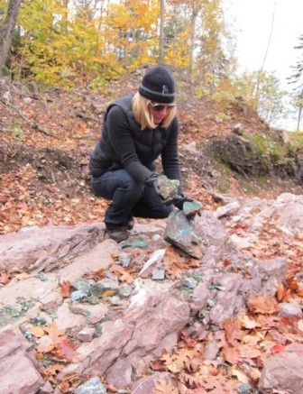 Superior's CEO and president, Judy Baker, examines the high-grade copper minerals on the Batchawana property.