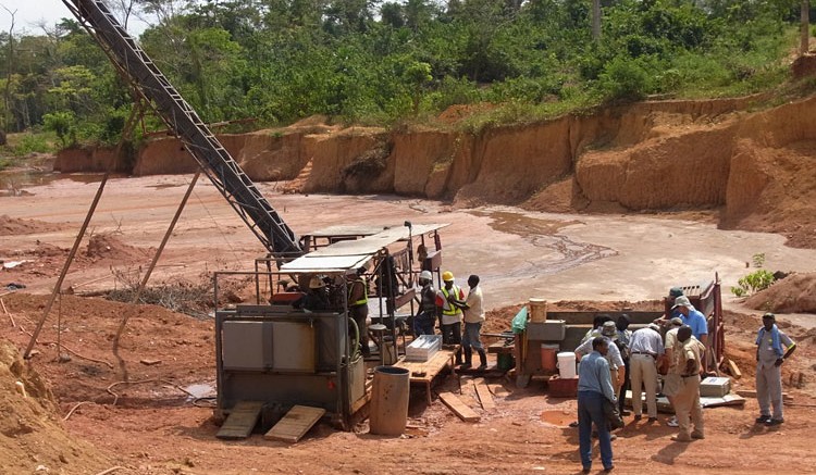 Workers set up equipment at PMI's Obotan project in Ghana. Source: PMI Gold