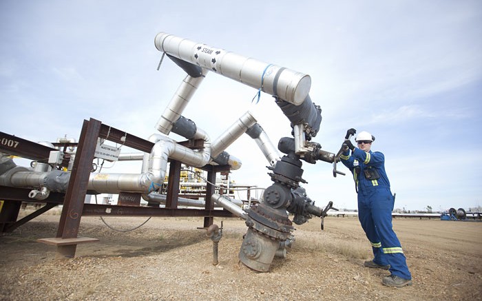 An operator tightens a valve on a steam-assisted gravity drainage well pad at Nexen's Long Lake oilsands project. Source: Nexen