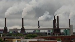 The smoke stacks at Rio Tinto's aluminum smelter rise above the rooftops in Shawinigan, Quebec. Photo by Michel Talbot.