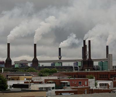 The smoke stacks at Rio Tinto's aluminum smelter rise above the rooftops in Shawinigan, Quebec. Photo by Michel Talbot.