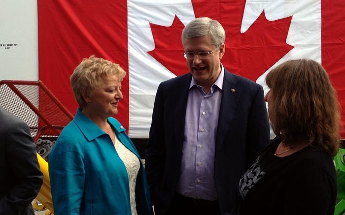 At the funding announcement for the Centre for Northern Innovation in Mining (CNIM) at Yukon College, from left: Yukon College president Karen Barnes, Prime Minister Stephen Harper and CNIM executive director Shelagh Rowles. Source: Yukon College