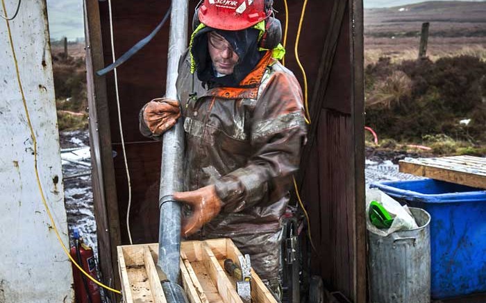 A worker places drill core in a container at Dalradian's Curraghinalt project in Northern Ireland. Credit: Dalradian Resources