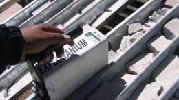 A worker takes measurements of rock samples. Credit: Macusani Yellowcake