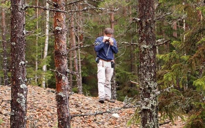 Eurasian Minerals' general manager of exploration inspects a rock at the Gumsberg copper-gold project in Sweden, the world's best mining jurisdiction in terms of mineral policy, according to the Fraser Institute. Photo by Gwen Preston.