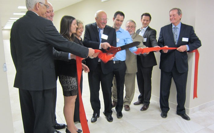 Actlabs founder and president Eric Hoffman cuts the ribbon to mark the opening of the firm's new facility in Ancaster, Ontario. Photo by Salma Tarikh.