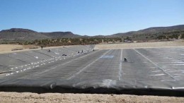 Workers lining a pond that will hold pregnant solution at Midway Gold's Pan gold project, 35 km southeast of Eureka, Nevada.  Credit: Midway Gold