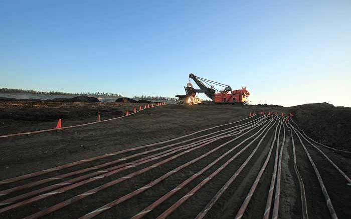 A shovel loads oilsands into a haul truck at Syncrude's Aurora mine in Alberta. Credit: Syncrude