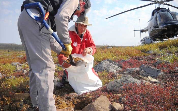 Helicopter pilot Tim Franke (standing) and geologist Bruce Kienlen sample till at Canterra Minerals' diamond project in the Southern Slave region of the Northwest Territories.  Credit: Canterra Minerals