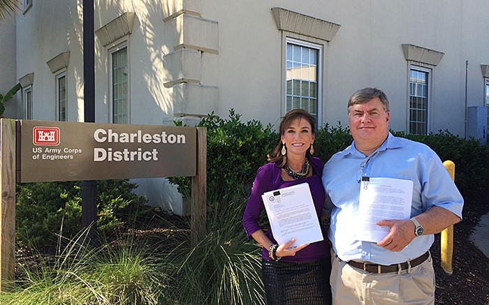 Romarco Minerals president and CEO Diane Garrett and COO Jim Arnold show off their Section 404 permit, which was granted in October for the Haile gold project in South Carolina. Credit: Romarco Minerals