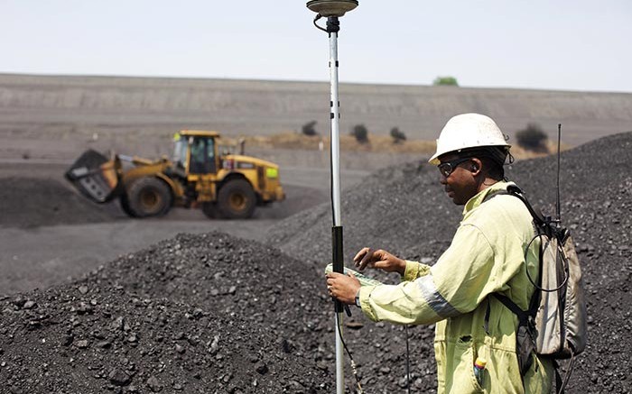 A surveyor measures a coal stockpile at Anglo American's Greenside thermal coal mine in South Africa. Credit: Anglo American
