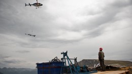 A helicopter drops off equipment to a drill platform at Tower Resources' JD project in B.C. Credit: Tower Resources
