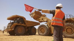 A worker directs traffic at Nordgold's Bissa gold mine in Guinea. Credit:  Nordgold
