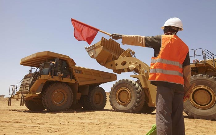 A worker directs traffic at Nordgold's Bissa gold mine in Guinea. Credit:  Nordgold