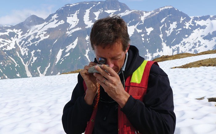 Warwick Board, Pretium Resources' chief geologist, inspects a sample while conducting regional exploration at the Brucejack gold project in British Columbia. Credit: Pretium Resources.