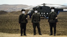 Soldiers guarding our Russian helicopter used to tour gold mines in North Korea in 1993. (Faces covered to hide their identities.)  Photo by David Tyrwhitt