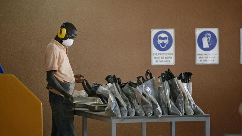 A worker bags samples at Orezone Gold's Bombore project in Burkina Faso. Credit: Orezone Gold