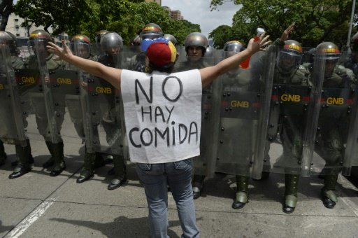 AFP photo of protester in Caracas, Venezuela, with sign reading "There is no food." Credit: AFP/file.