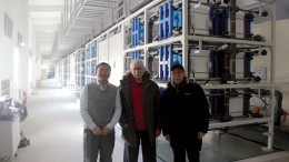 The project team in front of the 8 MW hour vanadium flow battery at the Zhangbei renewable energy project in February, 180 km north of Beijing, from left: chief technical officer Huang Mianyan, project coordinator Lee Barker and commercial manager Charles Ge. Credit: Sparton Resources.
