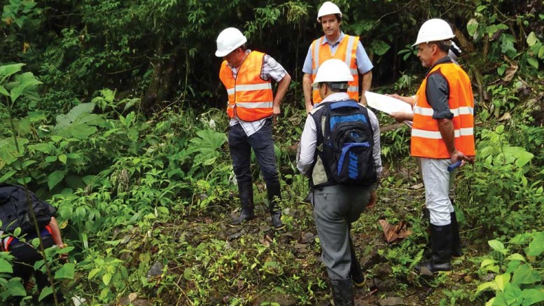 Inspecting drill collars at the Santa Barbara gold-copper prospect, part of Ecuador Gold and Copper’s Condor property in Ecuador, from left (in orange vests): Marshall Koval, Odin Mining’s president and CEO, and Odin directors John Youle and Diego Benalcazar.  Credit: Odin Mining.