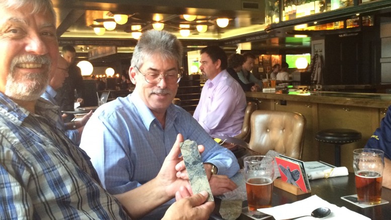 Serengeti Resources president and CEO David Moore (centre), passes around high-grade copper-gold core samples from the Kwanika project in B.C. at a lunch gathering in Vancouver. Credit: Robert Cameron.