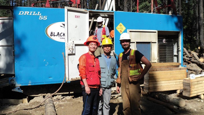 At a drill site on Serengeti Resources’ Kwanika copper-gold property, 250 km east of Smithers, B.C,. from left: Posco Daewoo’s Ji Su Go and Kyu-Youl Sung, and geologist Cole Godfrey. Credit: Serengeti Resources.